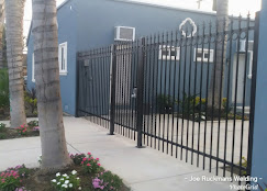 Custom black metal entry gate and matching fence sections installed at a home
